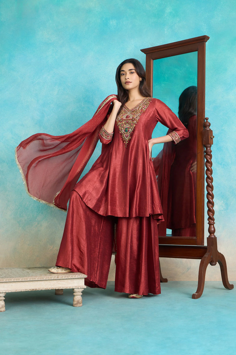 Elegant maroon Indian suit with embroidered kurta, palazzo pants, and dupatta, perfect for festive occasions